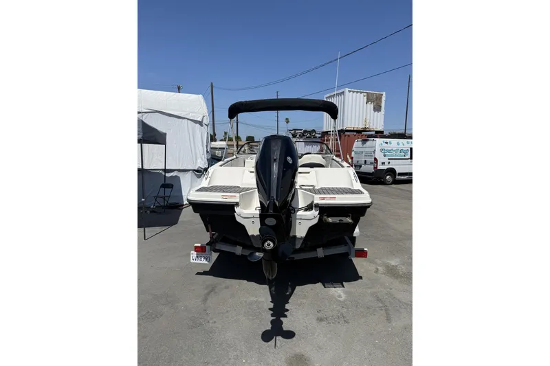 Slide: The Image of 2023 Bayliner VR4 Bowrider I/O boat, rear view, parked outdoors. - 9