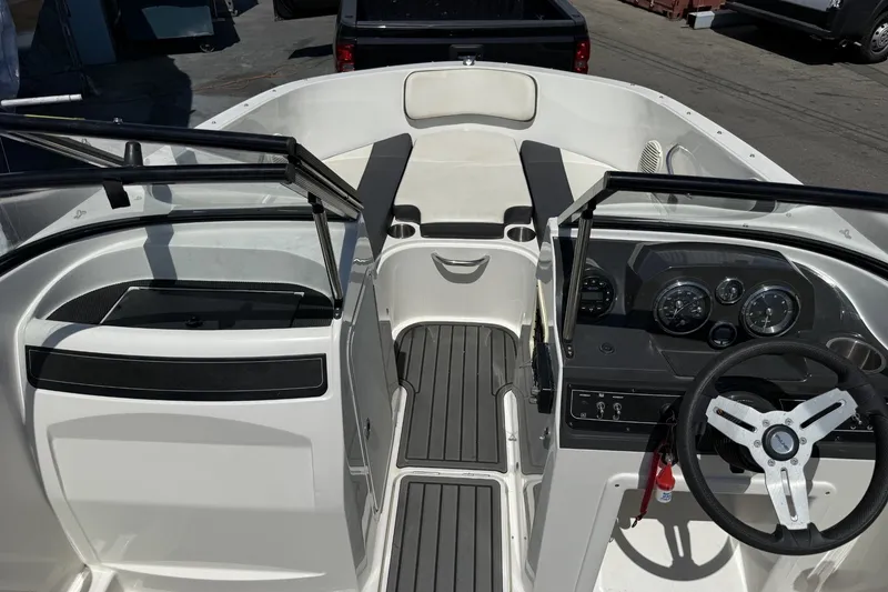 Slide: The Image of 2023 Bayliner VR4 Bowrider I/O interior with steering wheel and seating area. - 17