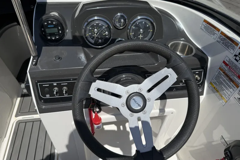 Slide: The Image of 2023 Bayliner VR4 Bowrider I/O dashboard with steering wheel and instrument panel. - 16