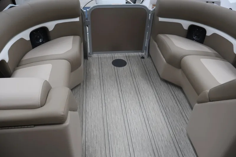 Slide: The Image of 2026 Premier 210 Sunsation RF - CL boat interior with beige seating and wood-style flooring. - 24