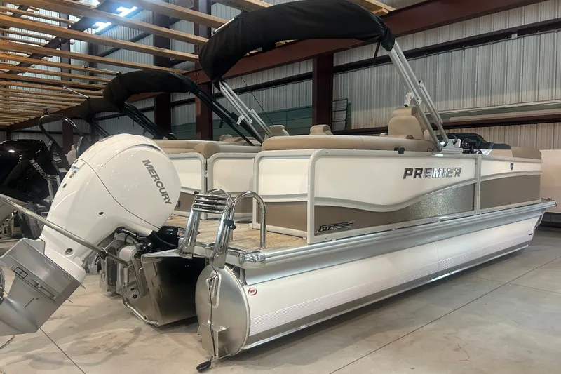 The Image of 2026 Premier 210 Sunsation RF - CL pontoon boat with Mercury outboard engine in a showroom. - 0