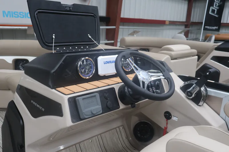 Slide: The Image of 2026 Premier 210 Sunsation RF - CL boat dashboard with steering wheel and controls. - 18