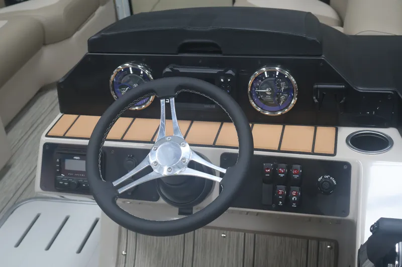 Slide: The Image of Steering console of 2026 Premier 210 Sunsation RF - CL boat with gauges and controls. - 20