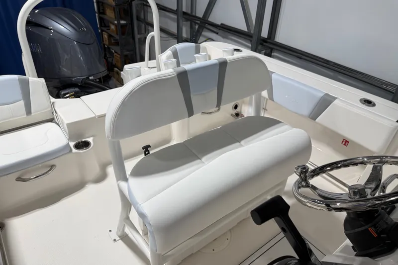 Slide: The Image of 2026 Robalo R200 Center Console boat interior with seating and steering wheel. - 2