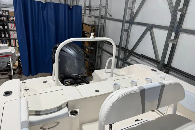Slide: The Image of 2026 Robalo R200 Center Console boat interior with engine and seating. - 4