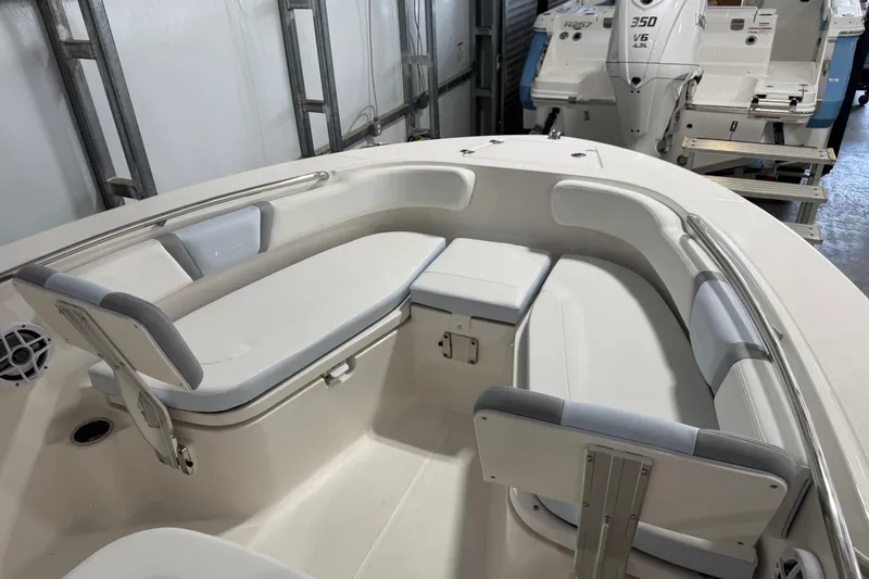 Slide: The Image of 2026 Robalo R200 Center Console boat interior with cushioned seating and storage compartments. - 9