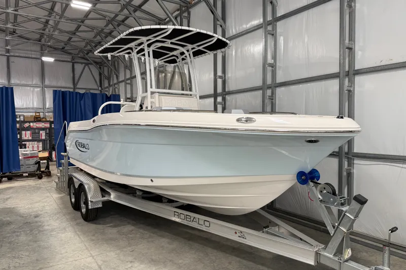 Slide: The Image of 2026 Robalo R200 Center Console boat on trailer in storage facility. - 0