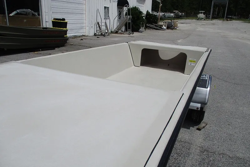 Slide: The Image of 2027 Delta Boatworks DELTA D1550 boat on trailer, parked outside a warehouse. - 14