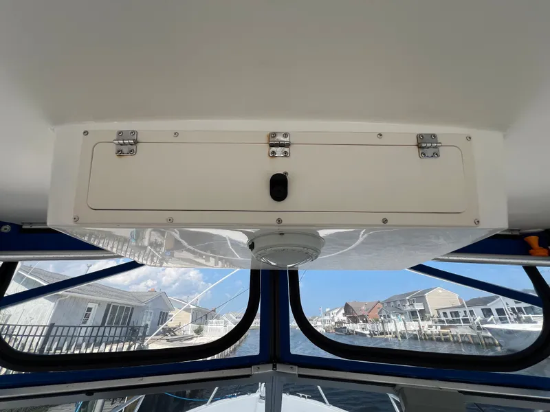 Slide: The Image of The cabin of a 2002 Albemarle 280 Express Fisherman with storage and windows overlooking the harbor. - 17