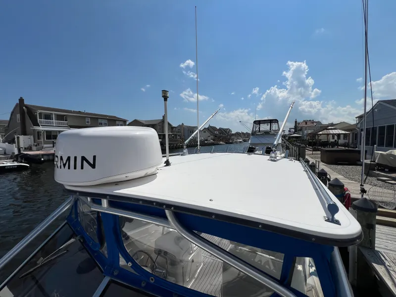 Slide: The Image of A 2002 Albemarle 280 Express Fisherman docked under a sunny sky with blue waters. - 22