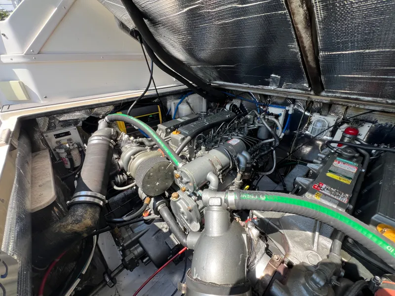 Slide: The Image of The engine compartment of a 2002 Albemarle 280 Express Fisherman shows a well-maintained engine. - 24
