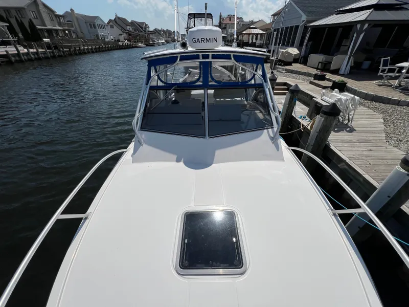 Slide: The Image of A 2002 Albemarle 280 Express Fisherman docked in a calm canal setting. - 20