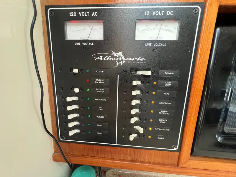 Slide: The Image of The image shows an electrical panel on a 2002 Albemarle 280 Express Fisherman boat. - 13