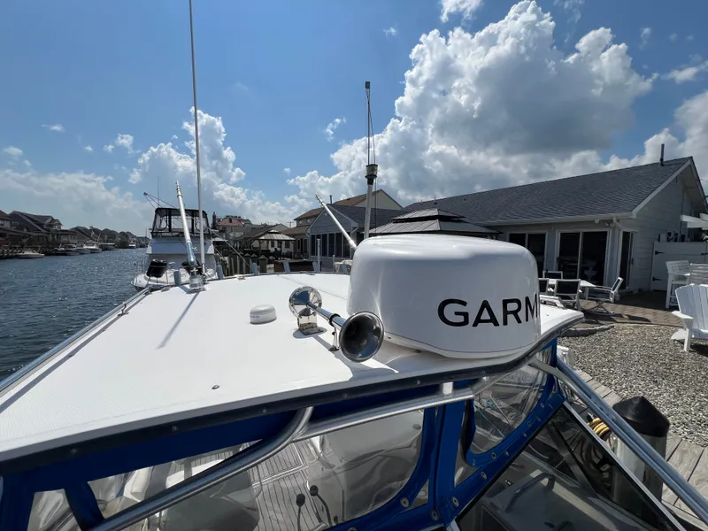Slide: The Image of A 2002 Albemarle 280 Express Fisherman docked. A Garmin radar is visible. - 21