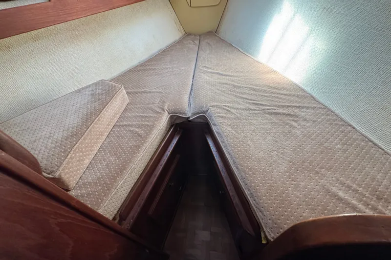 Slide: The Image of Cozy cabin interior of 1980 Morgan 382 sailboat with beige cushions and wooden accents. - 32