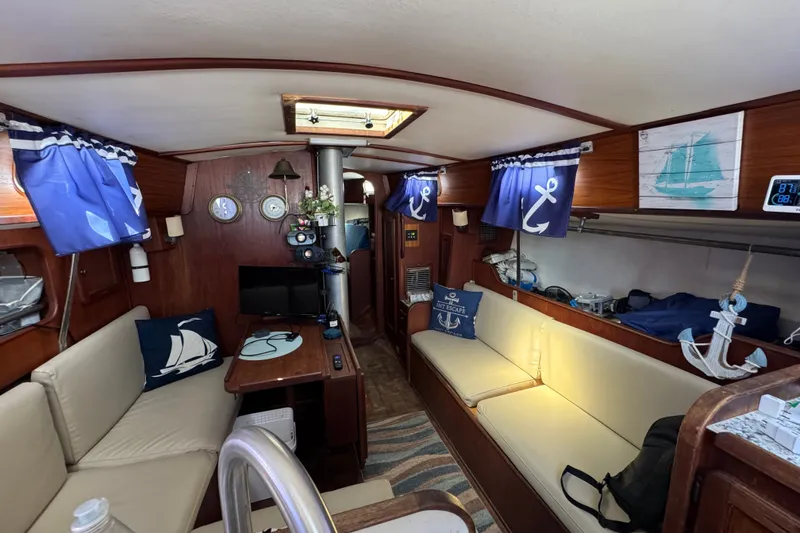 Slide: The Image of Interior of a 1980 Morgan 382 sailboat with nautical decor and cozy seating. - 21