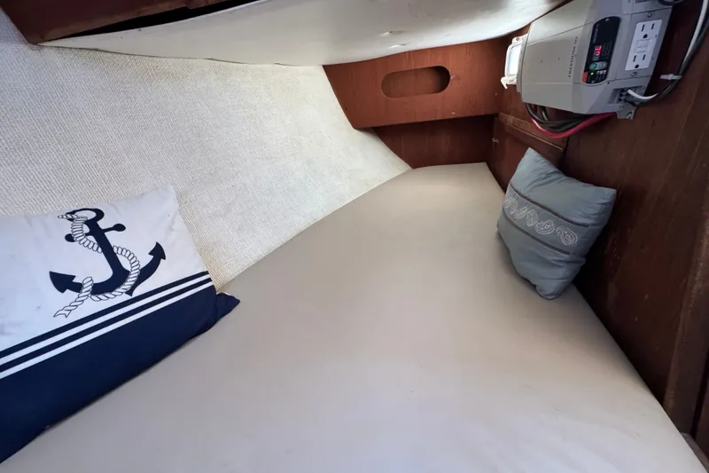 Slide: The Image of Cozy cabin interior of 1980 Morgan 382 sailboat with nautical-themed pillows. - 19
