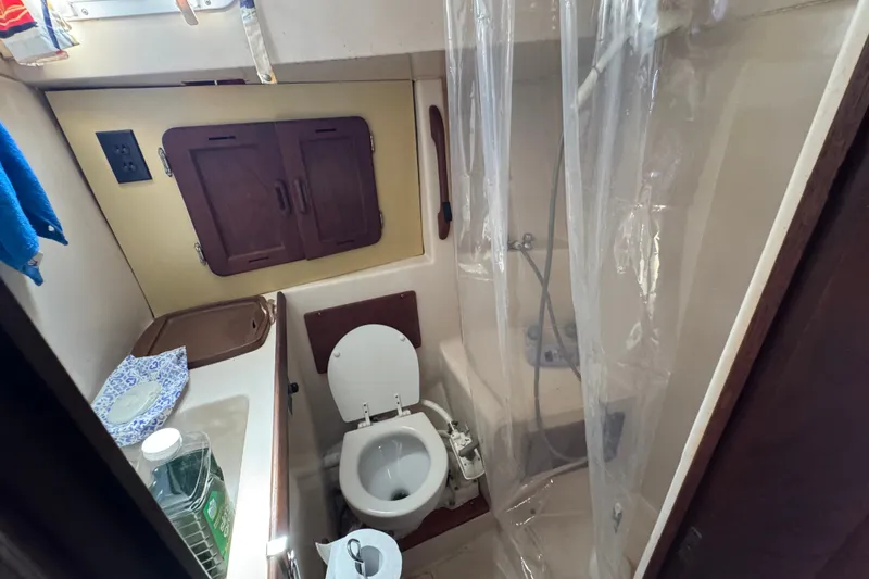 Slide: The Image of Compact bathroom in a 1980 Morgan 382 sailboat with toilet, sink, and shower. - 27