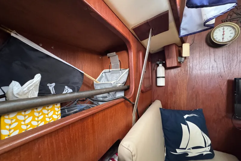 Slide: The Image of Interior of a 1980 Morgan 382 sailboat with nautical decor and storage shelves. - 24