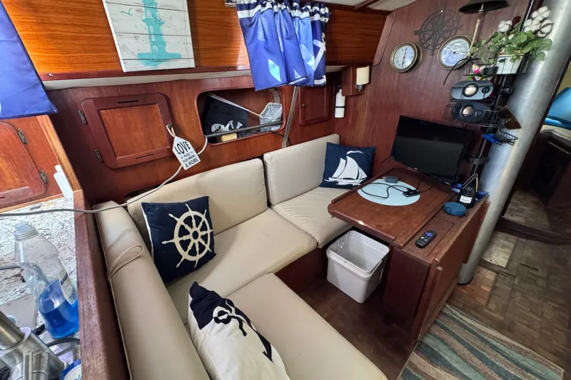 Slide: The Image of Cozy interior of a 1980 Morgan 382 sailboat with nautical decor and seating area. - 22