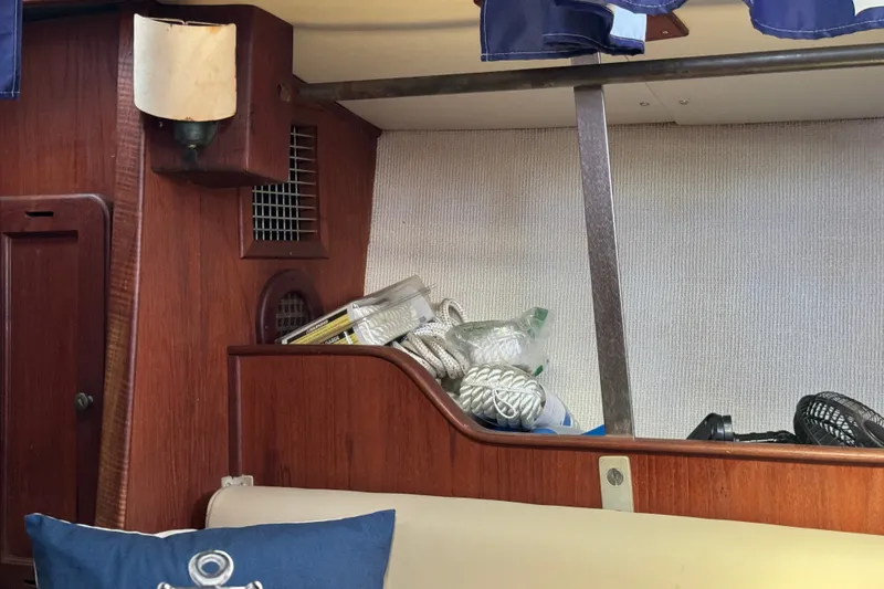 Slide: The Image of Interior of a 1980 Morgan 382 sailboat with wooden paneling and nautical decor. - 26