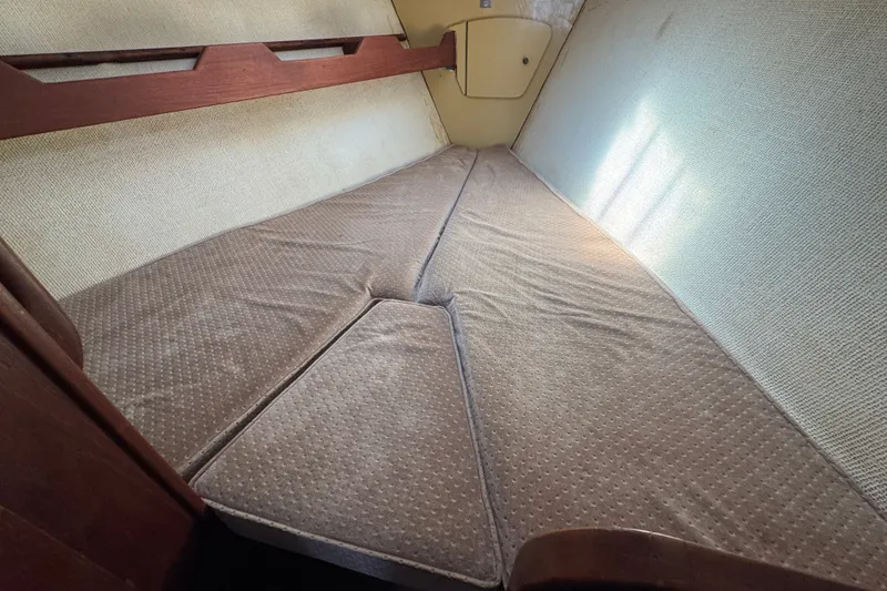 Slide: The Image of Interior cabin of a 1980 Morgan 382 sailboat with cushioned sleeping area. - 31
