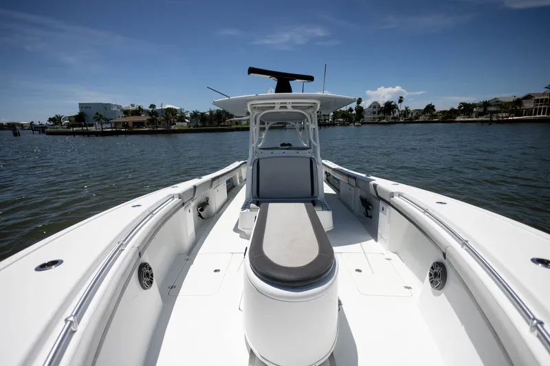 Slide: The Image of 2015 Yellowfin 39 Offshore boat on calm water, clear sky, coastal background. - 14
