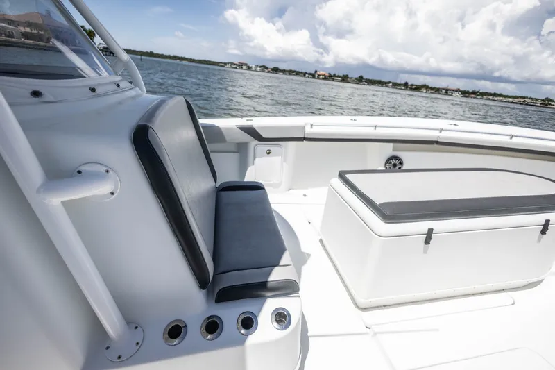 Slide: The Image of 2015 Yellowfin 39 Offshore boat interior with seating and storage, on calm waters. - 19