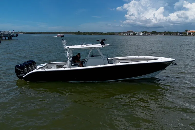 The Image of 2015 Yellowfin 39 Offshore boat on calm water, featuring triple Mercury engines. - 0