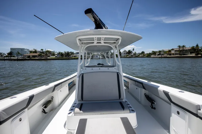 Slide: The Image of 2015 Yellowfin 39 Offshore boat on calm water, showcasing sleek design and spacious deck. - 18