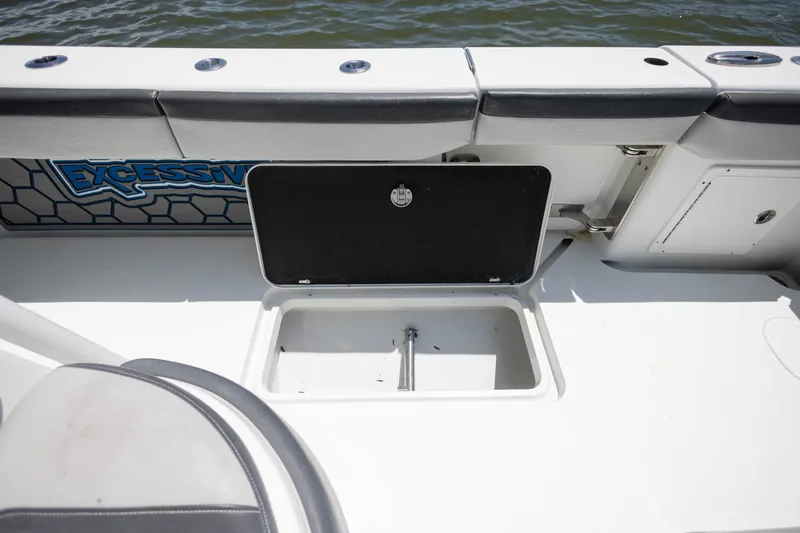 Slide: The Image of 2015 Yellowfin 39 Offshore boat deck with open storage compartment by the water. - 23