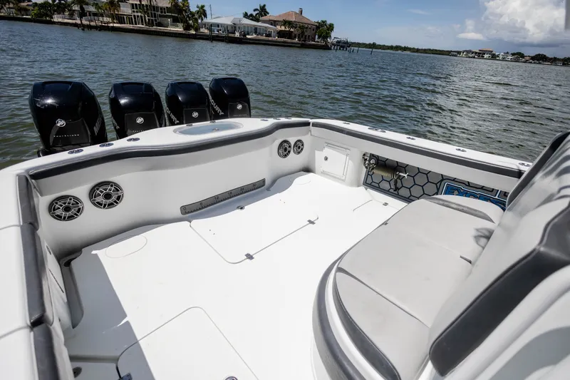 Slide: The Image of 2015 Yellowfin 39 Offshore boat interior with multiple outboard motors on a calm waterway. - 22