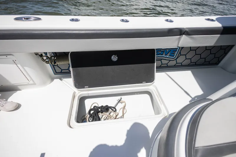 Slide: The Image of 2015 Yellowfin 39 Offshore boat storage compartment with ropes, on a sunny day. - 24