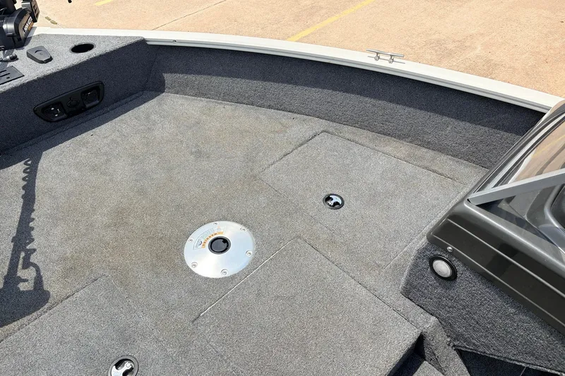 Slide: The Image of 2020 Tracker Pro Guide V-165 WT boat interior with carpeted deck and storage compartments. - 14