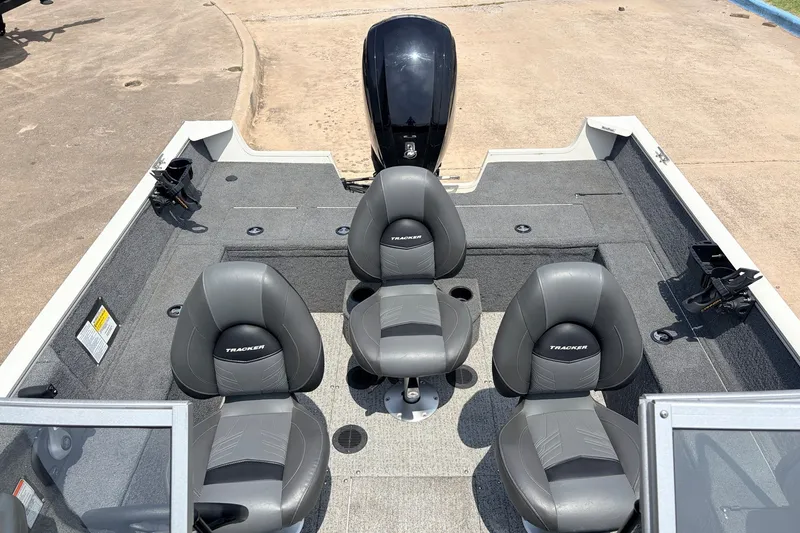Slide: The Image of 2020 Tracker Pro Guide V-165 WT boat interior with four gray seats and motor. - 23