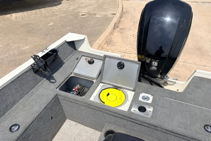 Slide: The Image of 2020 Tracker Pro Guide V-165 WT boat interior with storage compartments and motor. - 31