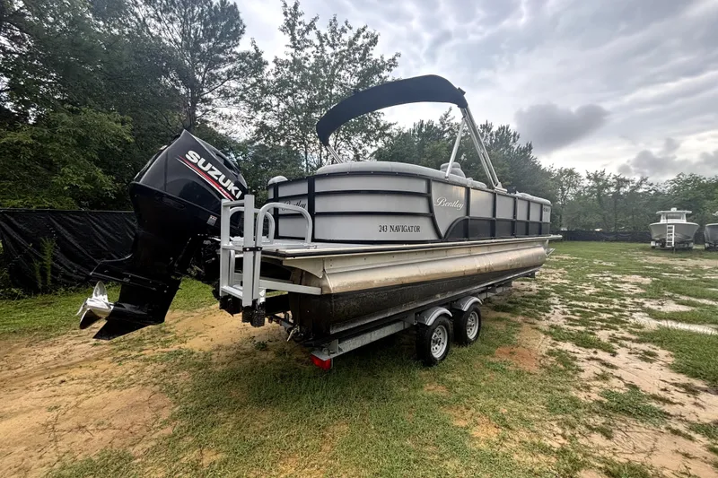 Slide: The Image of 2021 Bentley Pontoons 243 Navigator on trailer with Suzuki outboard motor. - 17