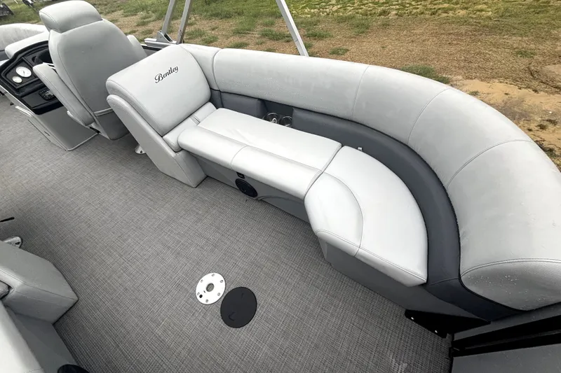 Slide: The Image of 2021 Bentley Pontoons 243 Navigator interior with gray seating and carpeted flooring. - 5