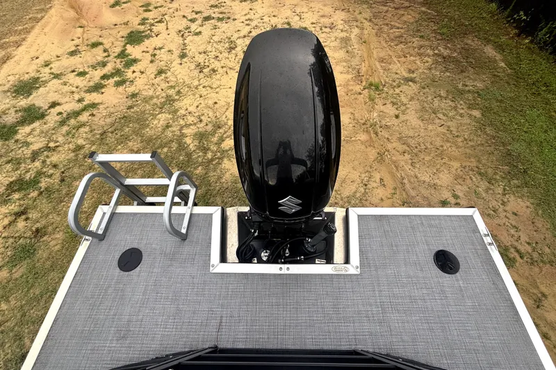 Slide: The Image of 2021 Bentley Pontoons 243 Navigator with Suzuki outboard motor on sandy terrain. - 12