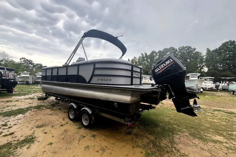 Slide: The Image of 2021 Bentley Pontoons 243 Navigator with Suzuki outboard motor on trailer, parked outdoors. - 15