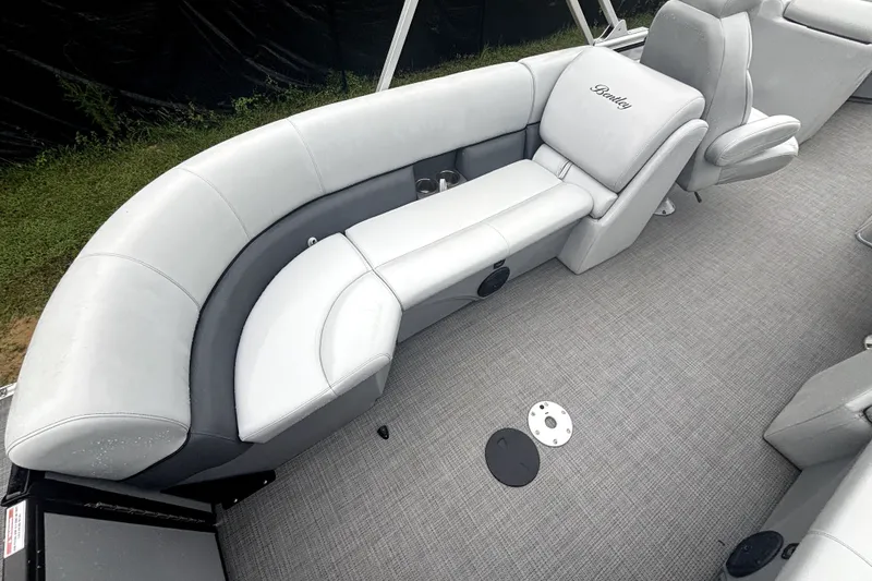 Slide: The Image of 2021 Bentley Pontoons 243 Navigator interior with gray seating and carpeted flooring. - 6