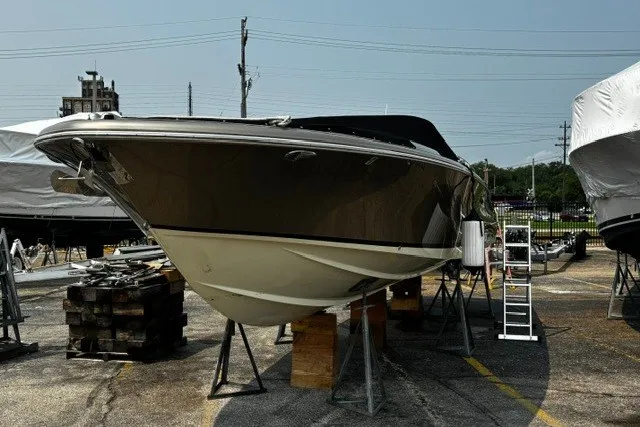 Slide: The Image of 2014 Chris-Craft Launch 32 boat on stands in a marina, ready for maintenance. - 21