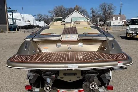 Slide: The Image of 2014 Chris-Craft Launch 32 boat, rear view, parked on trailer in outdoor setting. - 13