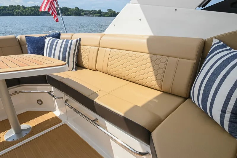 Slide: The Image of Luxurious seating area on 2024 Sea Ray Sundancer 320 yacht with stylish cushions and table. - 22
