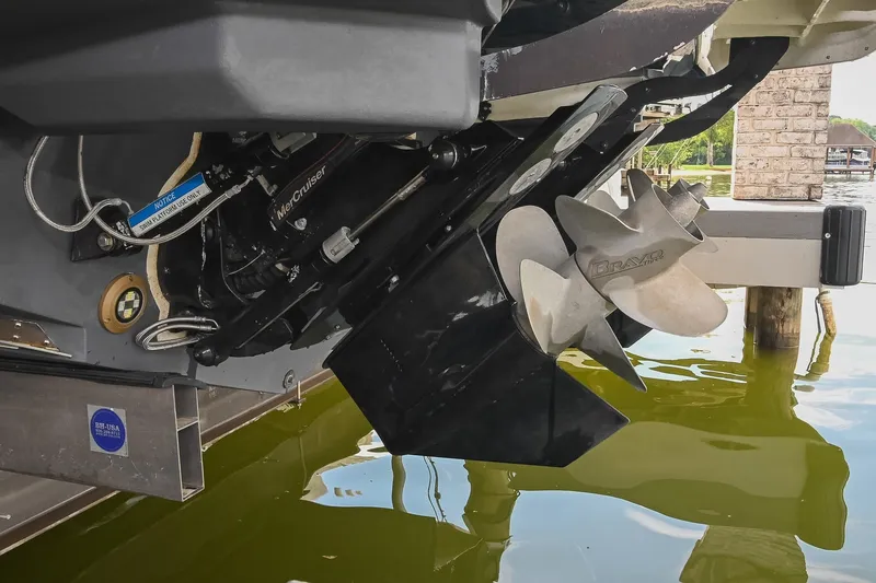 Slide: The Image of 2024 Sea Ray Sundancer 320 boat propeller and engine detail in water. - 80