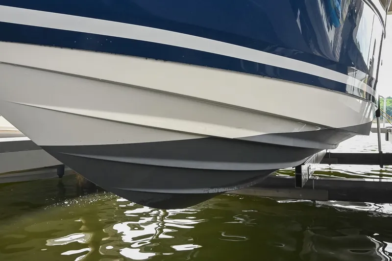 Slide: The Image of 2024 Sea Ray Sundancer 320 hull design, docked above water, showcasing sleek lines and craftsmanship. - 78