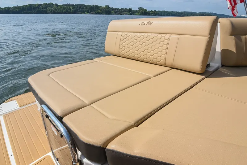 Slide: The Image of 2024 Sea Ray Sundancer 320 boat with luxurious tan seating on a serene lake. - 30