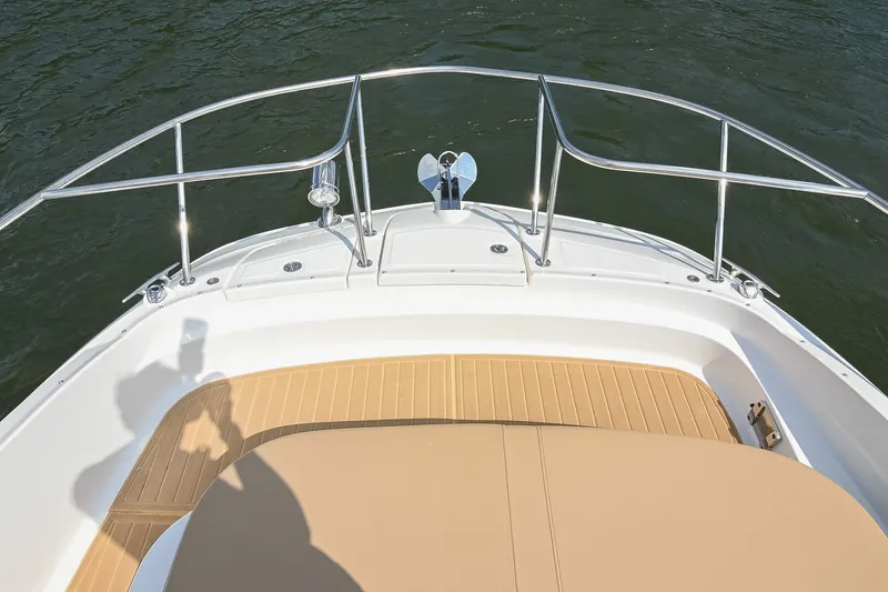 Slide: The Image of 2024 Sea Ray Sundancer 320 bow with stainless steel railings and teak deck. - 49