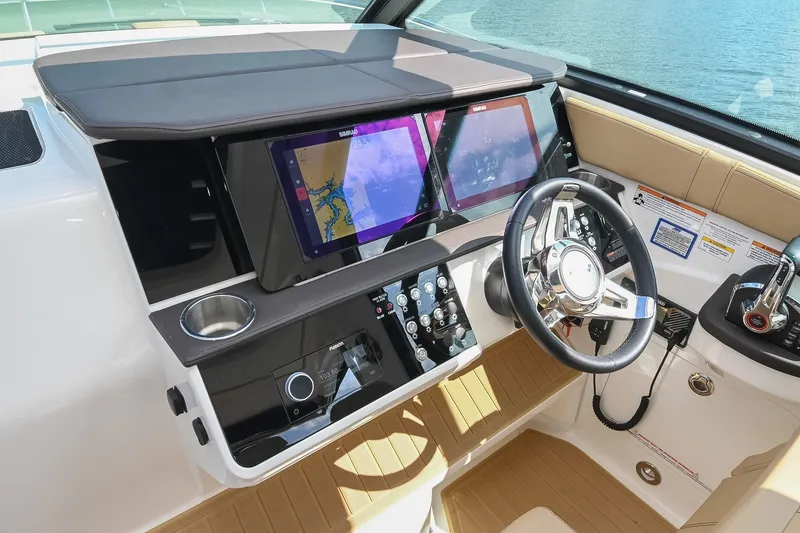 Slide: The Image of 2024 Sea Ray Sundancer 320 helm with dual navigation screens and modern controls. - 35