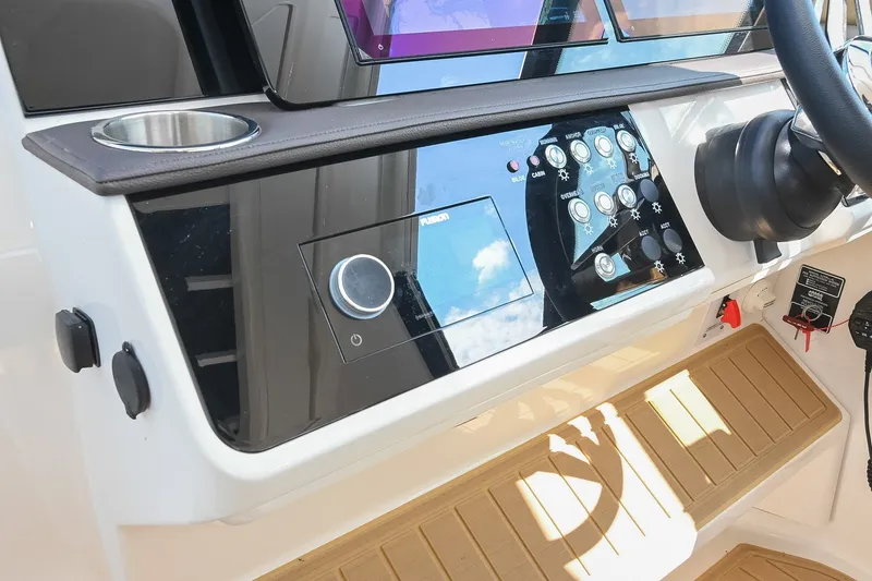 Slide: The Image of 2024 Sea Ray Sundancer 320 helm with modern controls and navigation system. - 47